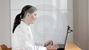 Telemedicine concept: doctor during a video consult with a coughing patient.