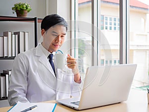 Telemedicine Coronavirus concept. Doctor working with mobile phone and stethoscope and digital tablet laptop in modern office at