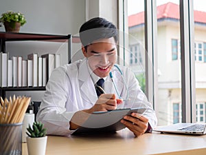 Telemedicine Coronavirus concept. Doctor working with mobile phone and stethoscope and digital tablet laptop in modern office at