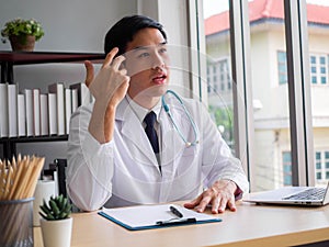 Telemedicine Coronavirus concept. Doctor working with mobile phone and stethoscope and digital tablet laptop in modern office at