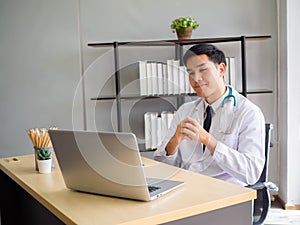 Telemedicine Coronavirus concept. Doctor working with mobile phone and stethoscope and digital tablet laptop in modern office at