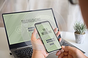 Telemedicine online application background concept. Mockup mobile phone and laptop, a person holding smartphone using the