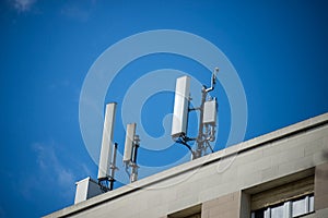 telephone antenna relay on the roof of building on blue sky background