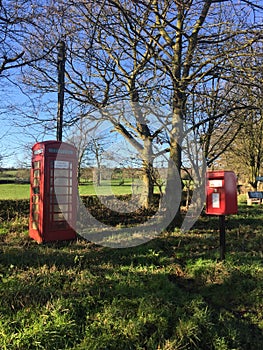 Telephone box and postage box in the countryside.