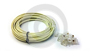 Telephone cable and pile of RJ11 isolated on white paper photo