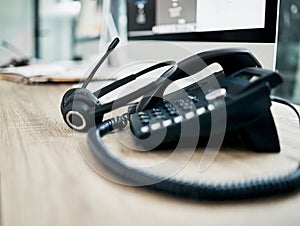 Telephone, contact us with call center, communication and headphone with microphone on work desk. Contact center