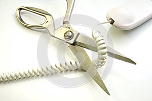 Telephone cord being cut by scissors