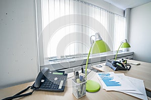 Telephone and green lamps in a office