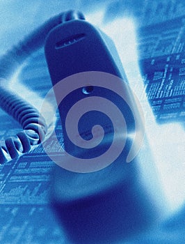 Telephone handset on financial page