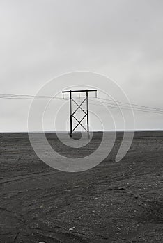 Telephone line in the middle of a volcanic rock field