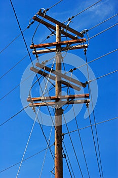 Telephone pole on blue sky