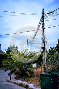 Telephone pole overloaded with cables