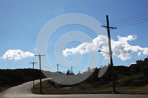 Telephone pole with wires on an empty street