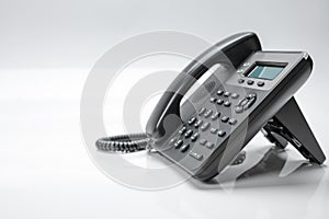 Telephone set with display and buttons. Modern phone for ip-telephony. Isolated, white background