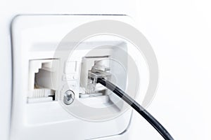 Telephone socket and telephone cable on the wall
