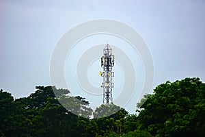 Telephone towers are placed near forests in populated areas of India.