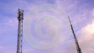 Telephony antennas and communication towers on pink blue ciel