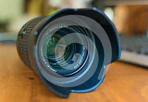 A telephoto camera lens with it`s lens hood on.