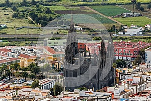 Telephoto lens shot. Aerial view of historic town Arucas with impressive cathedral. Gran Canaria, Canary islands, Spain