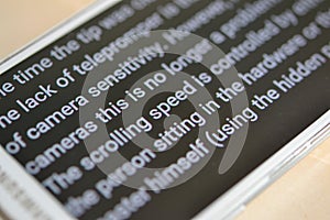 Teleprompter automatically scrolls text close-up. photo