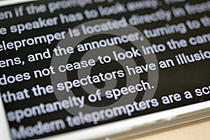 Teleprompter automatically scrolls text close-up. photo