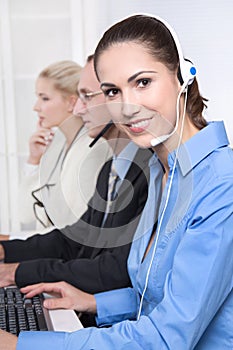 Telesales or helpdesk team - helpful woman with headset smiling photo