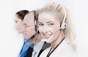 Telesales or helpdesk team - helpful woman with headset smling a