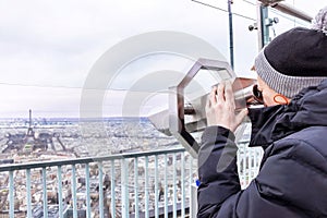 Telescope of Montparnasse. Boy is looking to Eiffel tower.