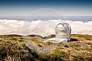 Telescope on a mountain. Landcape above the clouds. Large telescope dome. Gran Telescopio Canarias. Roque de los Muchachos