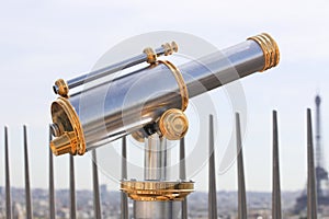 telescope overlooking for paris from top of the eiffel tower Paris , France