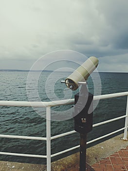 Telescope on the pier on clody day