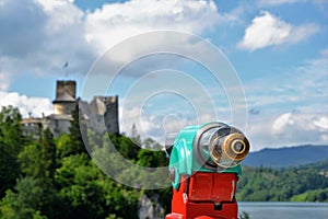 Telescope with the view on Niedzica Castle also known as Dunajec Castle  in Niedzica, Poland