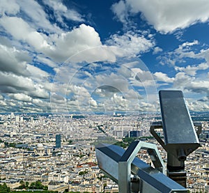 Telescope viewer and city skyline at daytime (against the background of very beautiful clouds). Paris, France.