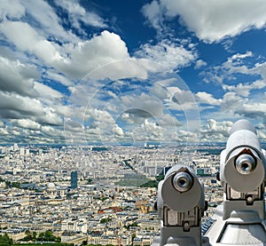 Telescope viewer and city skyline at daytime (against the background of very beautiful clouds). Paris, France.