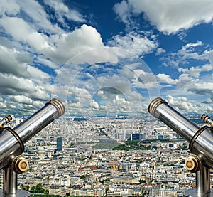 Telescope viewer and city skyline at daytime (against the background of very beautiful clouds). Paris, France.