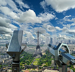 Telescope viewer and city skyline at daytime (against the background of very beautiful clouds). Paris, France