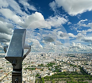 Telescope viewer and city skyline at daytime (against the background of very beautiful clouds). Paris, France