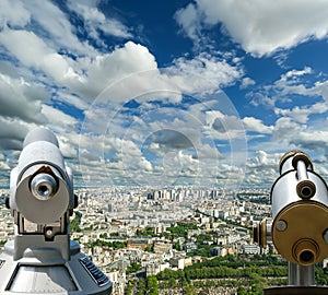 Telescope viewer and city skyline at daytime (against the background of very beautiful clouds). Paris, France