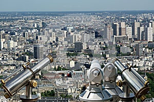 Telescope viewer and city skyline at daytime. Paris, France.
