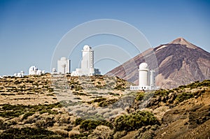 Telescopes of Tenerife. SLOOH observatory in las canadas national park. Telescope domes with El Teide volcano in the background. photo