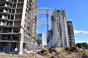 Telescopic handler work at the construction site. Construction machinery for loading. Tower crane during construct a multi-storey