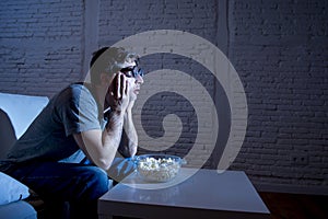 Television addict man on sofa watching TV and eating popcorn in funny nerd geek glasses