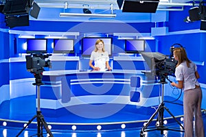 Television anchorwoman and teleoperator work at TV studio