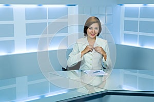 Television anchorwoman at TV studio photo