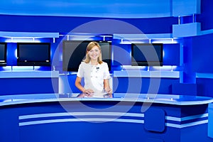 Television anchorwoman at TV studio photo