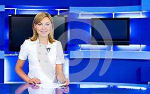 Television anchorwoman at TV studio photo