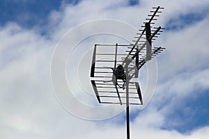 Television antennae on clouded sky