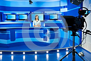 Television newscaster at blue TV studio