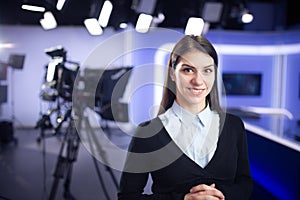 Television presenter recording in news studio. Female journalist anchor presenting business report photo