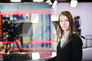 Television presenter recording in news studio.Female journalist anchor presenting business report,recording in television studio